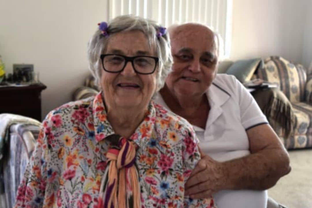 Older couple sitting side by side at home. Symbolic of our services - Wills and Estate Lawyer North Brisbane.